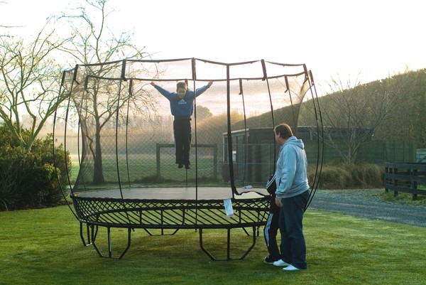 All Black's Assistant Coach Steve Hansen with his kids enjoying safe jumping in their trampoline.